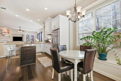 a view of a dining room with furniture and a kitchen