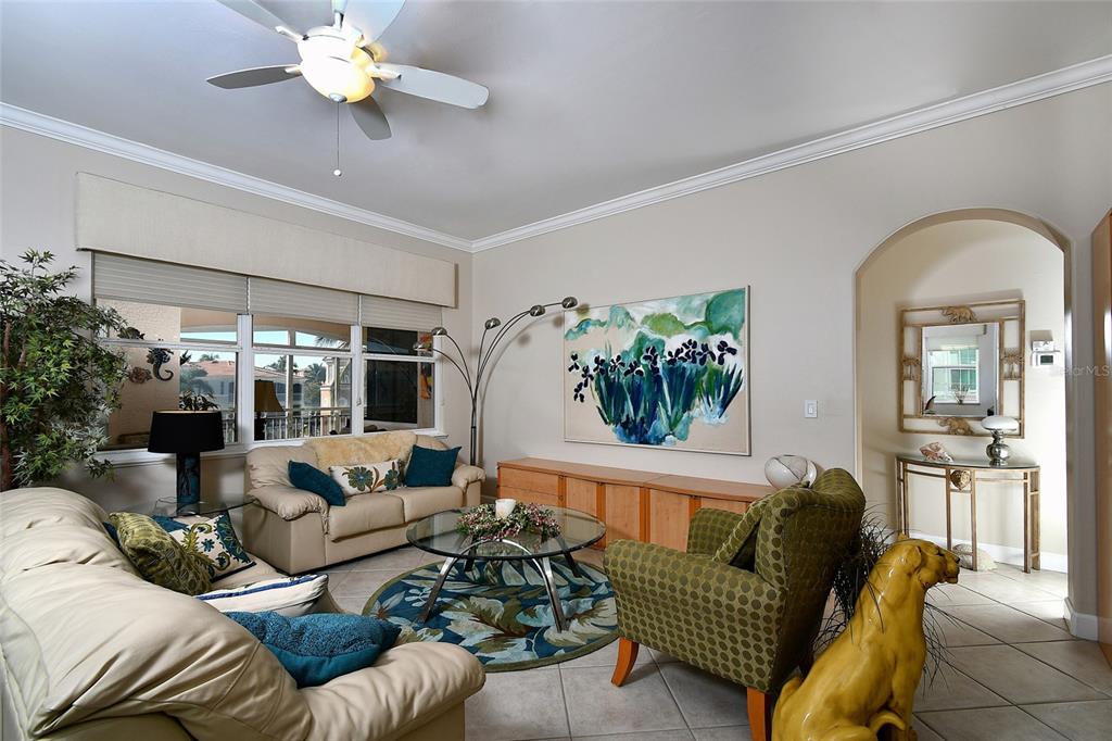 3454 Sunset Key Circle, Unit 103 Punta Gorda, FL 33955 - Photo 15 of 37 a living room with furniture and a large window