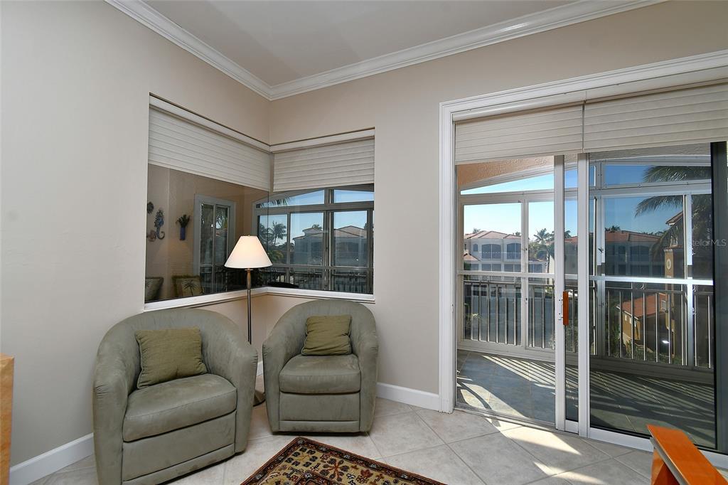 3454 Sunset Key Circle, Unit 103 Punta Gorda, FL 33955 - Photo 17 of 37 a living room with furniture and a large window