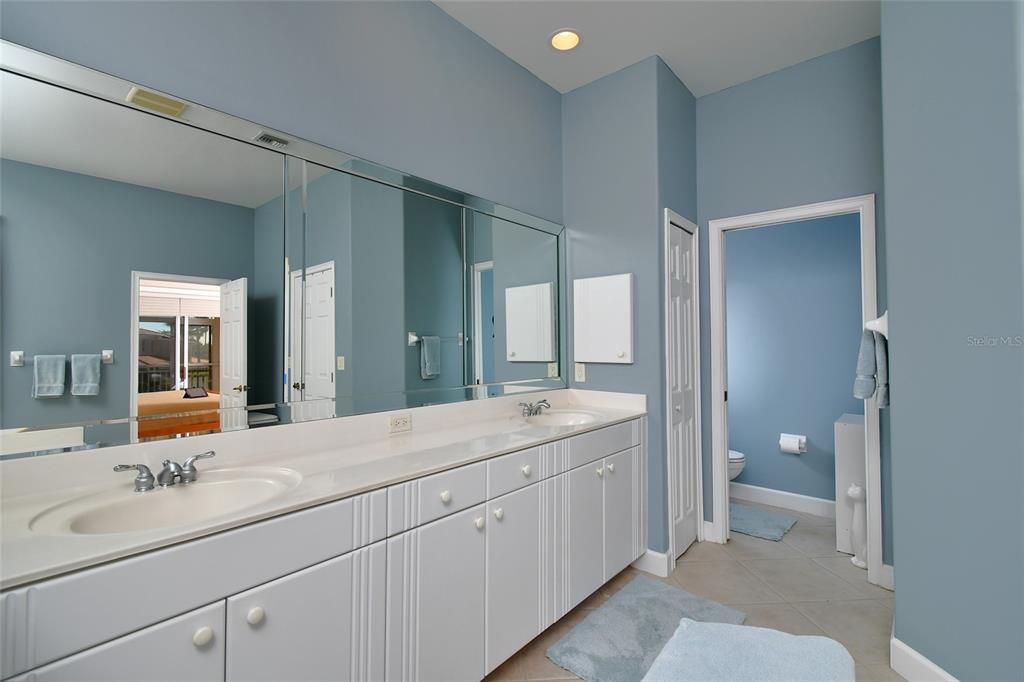 3454 Sunset Key Circle, Unit 103 Punta Gorda, FL 33955 - Photo 22 of 37 a en suite bathroom with a granite countertop sink mirror and toilet
