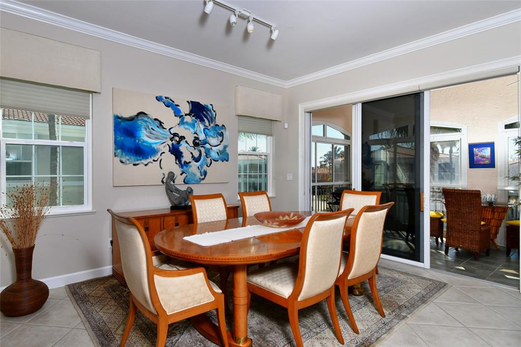 3454 Sunset Key Circle, Unit 103 Punta Gorda, FL 33955 - Photo 23 of 37 a dining room with furniture potted plants and a table