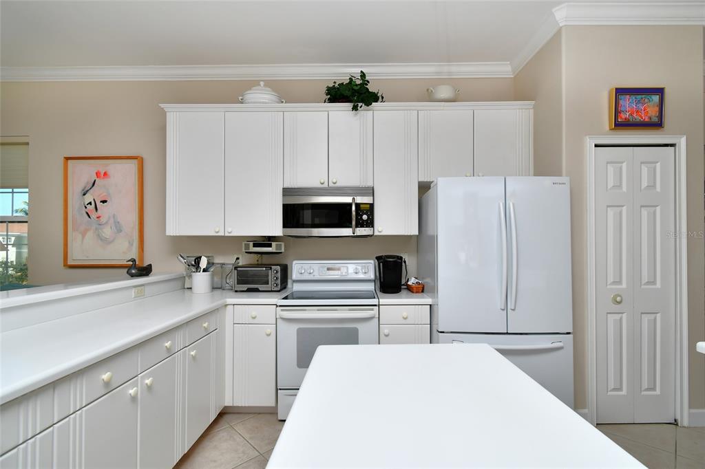 3454 Sunset Key Circle, Unit 103 Punta Gorda, FL 33955 - Photo 26 of 37 a kitchen with stainless steel appliances a refrigerator sink and white cabinets