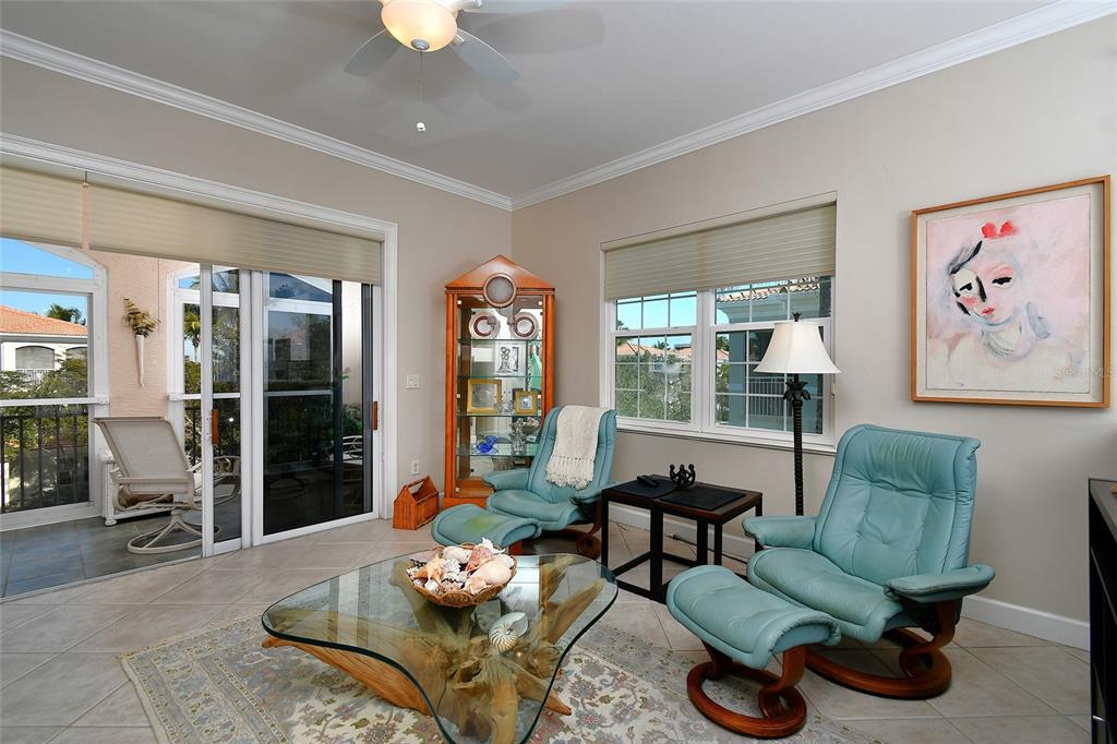 3454 Sunset Key Circle, Unit 103 Punta Gorda, FL 33955 - Photo 28 of 37 a living room with furniture and a chandelier