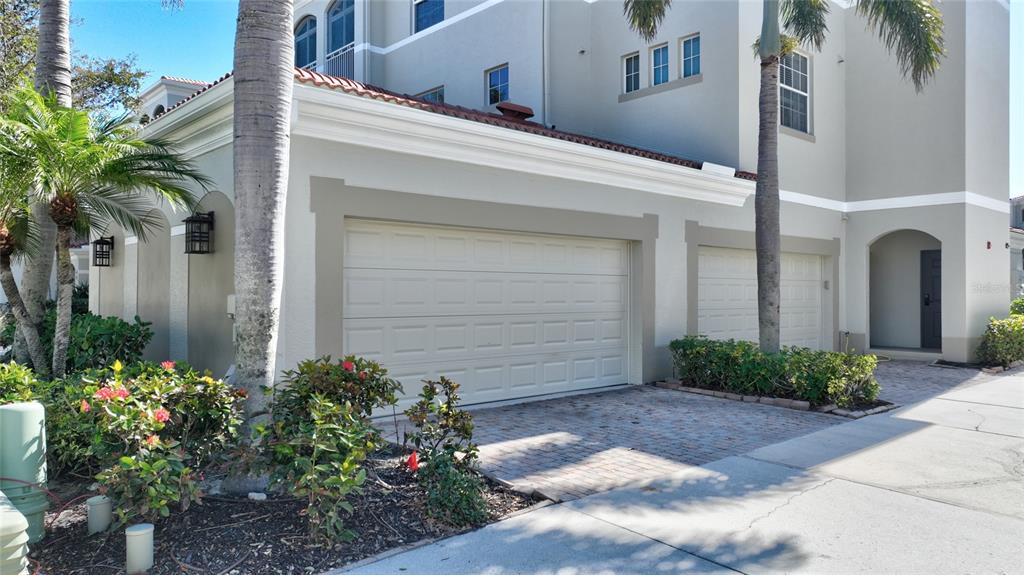 3454 Sunset Key Circle, Unit 103 Punta Gorda, FL 33955 - Photo 3 of 37 a front view of a house with a yard and potted plants