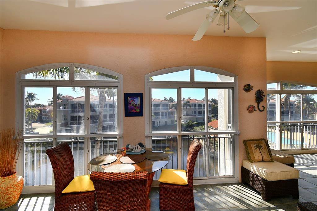 3454 Sunset Key Circle, Unit 103 Punta Gorda, FL 33955 - Photo 32 of 37 a living room with furniture and a large window