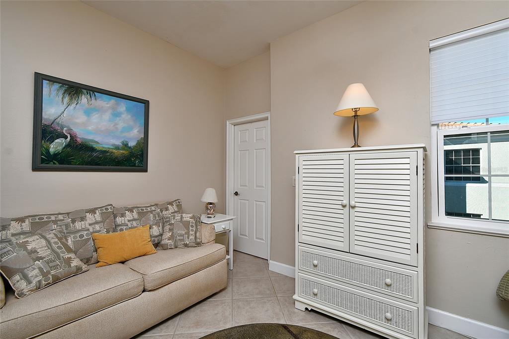 3454 Sunset Key Circle, Unit 103 Punta Gorda, FL 33955 - Photo 8 of 37 a living room with furniture and a lamp
