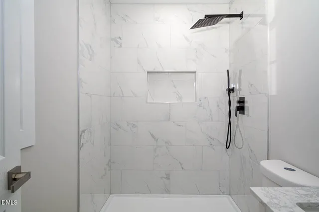 a bathroom with a shower and toilet