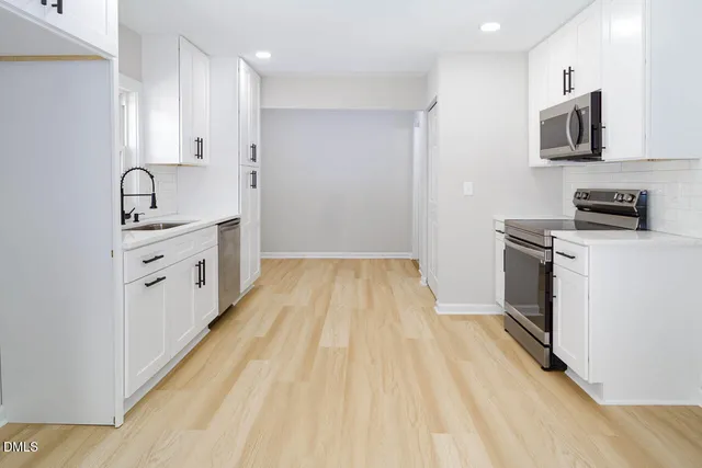 a view of a kitchen with electric appliances