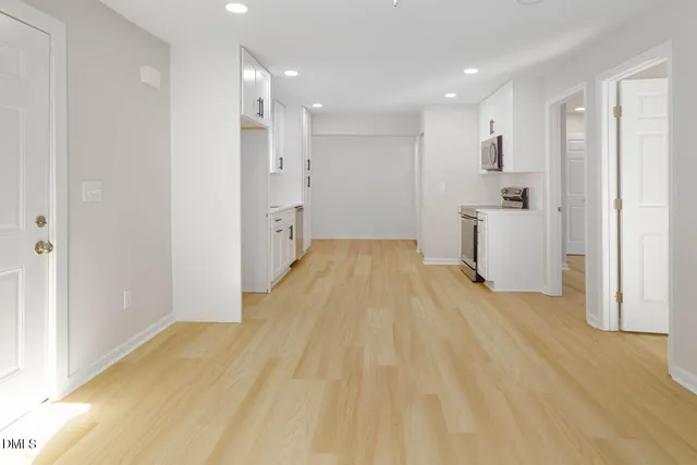 a view of a kitchen with a sink and wooden floor