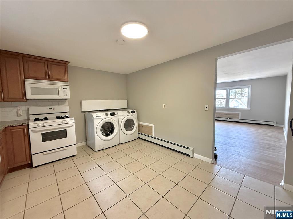175 Van Winkle Street, Unit 2 East Rutherford, NJ 07073 - Photo 11 of 20 a kitchen with a stove top oven and cabinets