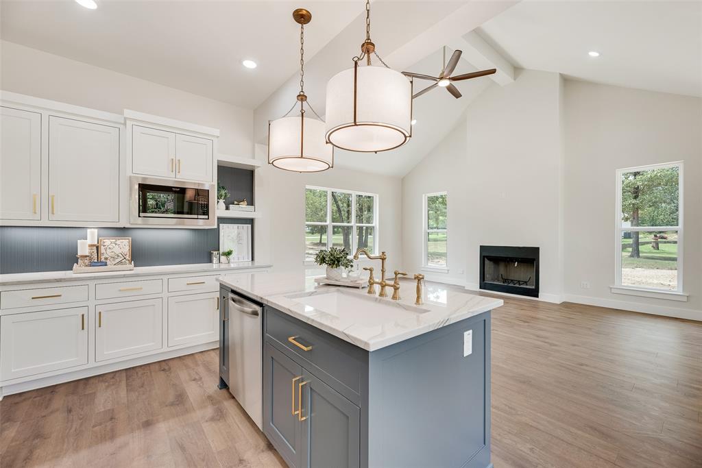 322 Rs Co Road Alba, TX 75410 - Photo 11 of 37 Kitchen featuring white cabinets, decorative light fixtures, beamed ceiling, high vaulted ceiling, and light wood-type flooring