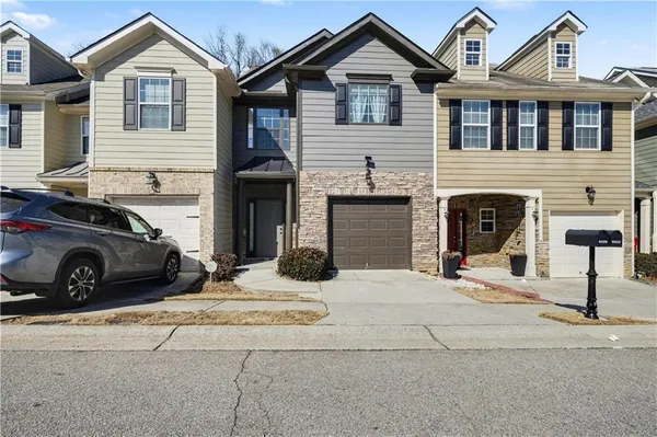 a view of a car parked in front of a house