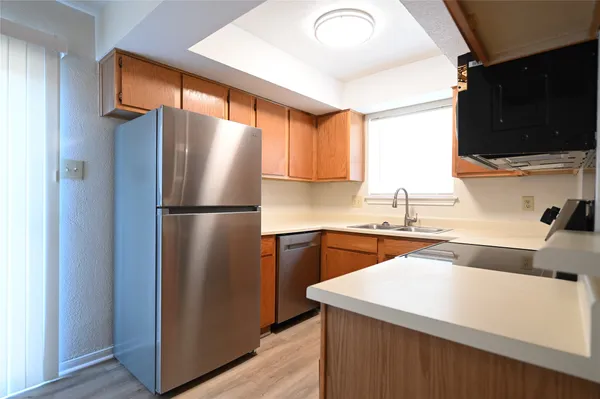 a kitchen with stainless steel appliances granite countertop a refrigerator and a sink