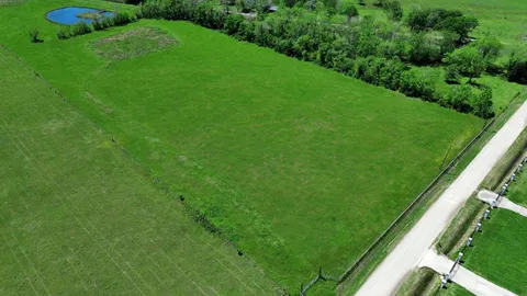 a view of a field of grass and trees