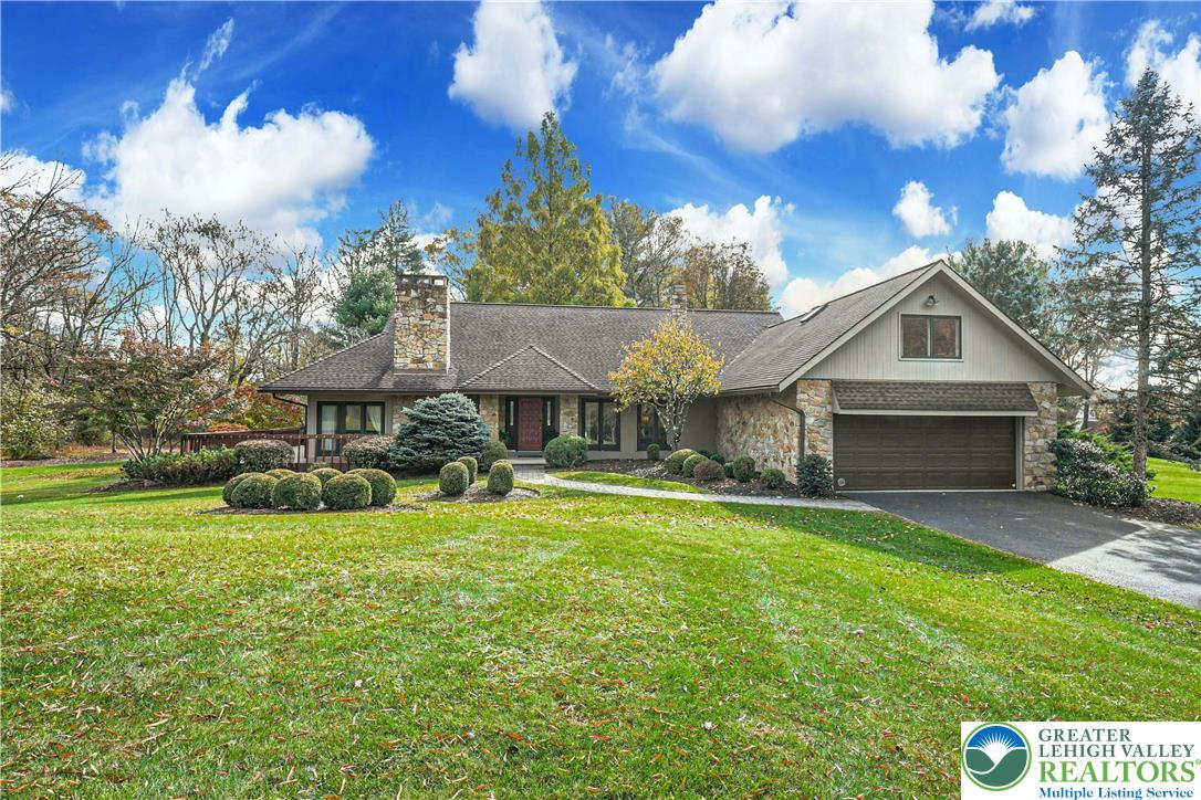 1588 Saucon Valley Road Bethlehem, PA 18015 - Photo 1 of 35 a front view of a house with a garden and yard