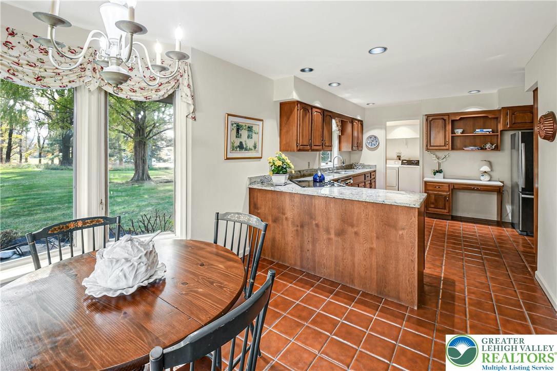 1588 Saucon Valley Road Bethlehem, PA 18015 - Photo 14 of 35 a view of a dining room with furniture a chandelier and wooden floor