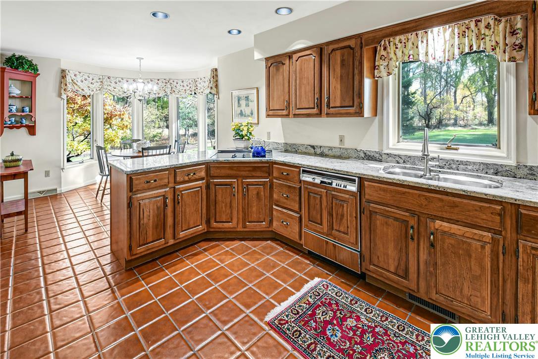 1588 Saucon Valley Road Bethlehem, PA 18015 - Photo 16 of 35 a kitchen with stainless steel appliances granite countertop a sink stove and cabinets
