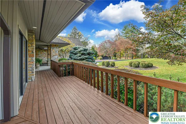 a balcony with wooden floor and outdoor space