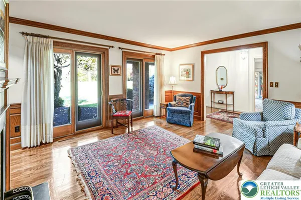 a living room with furniture a rug and a large window
