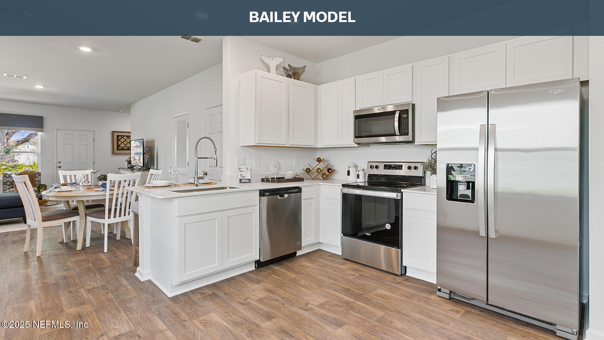 275 Counsel Street Yulee, FL 32097 - Photo 6 of 20 a kitchen with white cabinets and stainless steel appliances