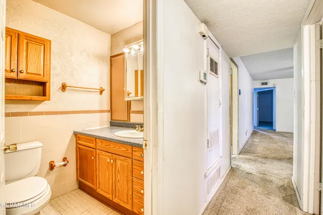 an empty room with fireplace and fan