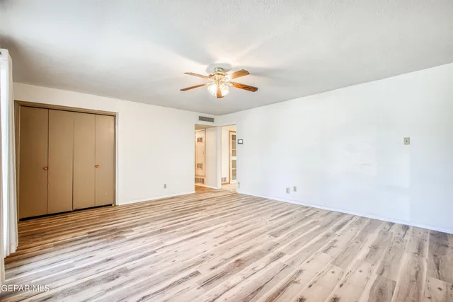 an empty room with a fireplace and window