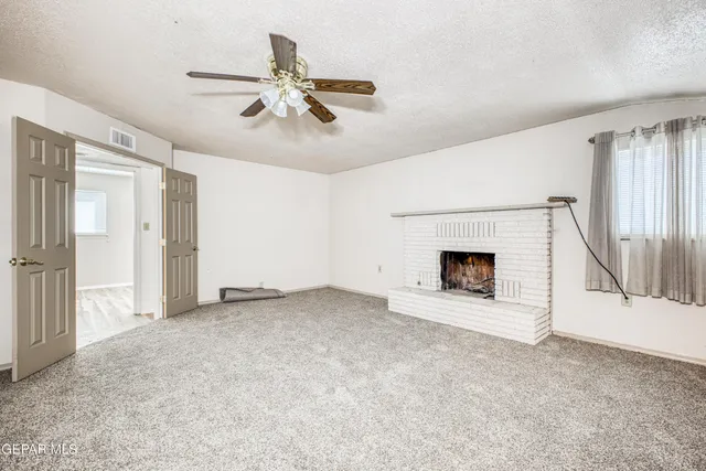 a view of a livingroom with a chandelier fan
