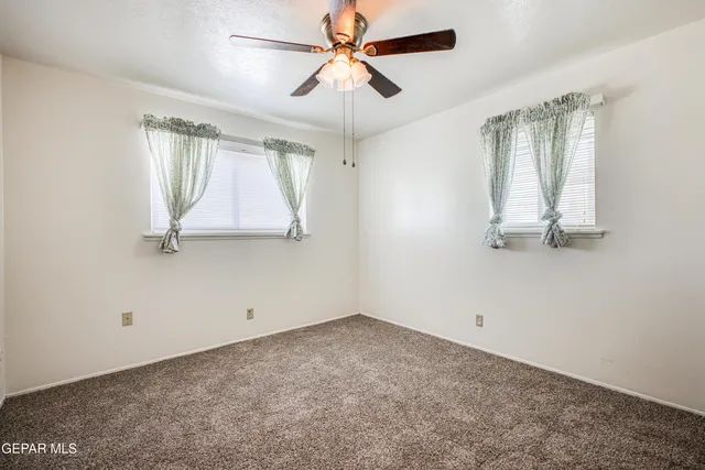 a kitchen with granite countertop a sink cabinets stainless steel appliances and a window