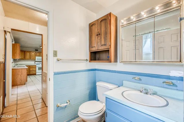 a bathroom with a sink a toilet and mirror
