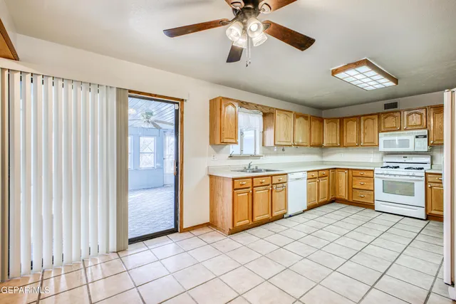 a large kitchen with a stove a sink dishwasher and a refrigerator
