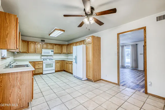 a kitchen with granite countertop cabinets stainless steel appliances and a sink