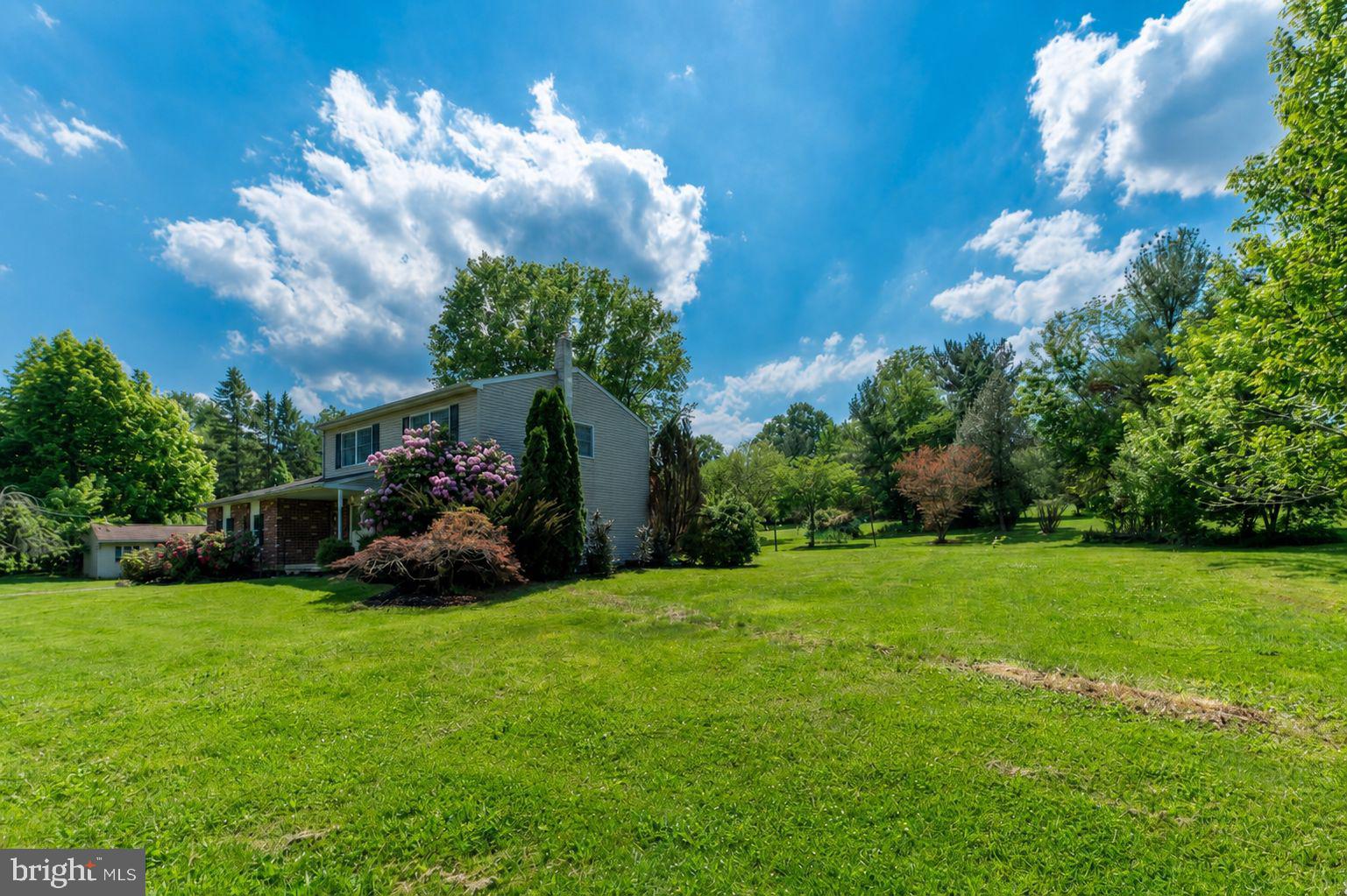 223 Trythall Road Elverson, PA 19520 - Photo 6 of 78 a view of a house with a big yard and large trees