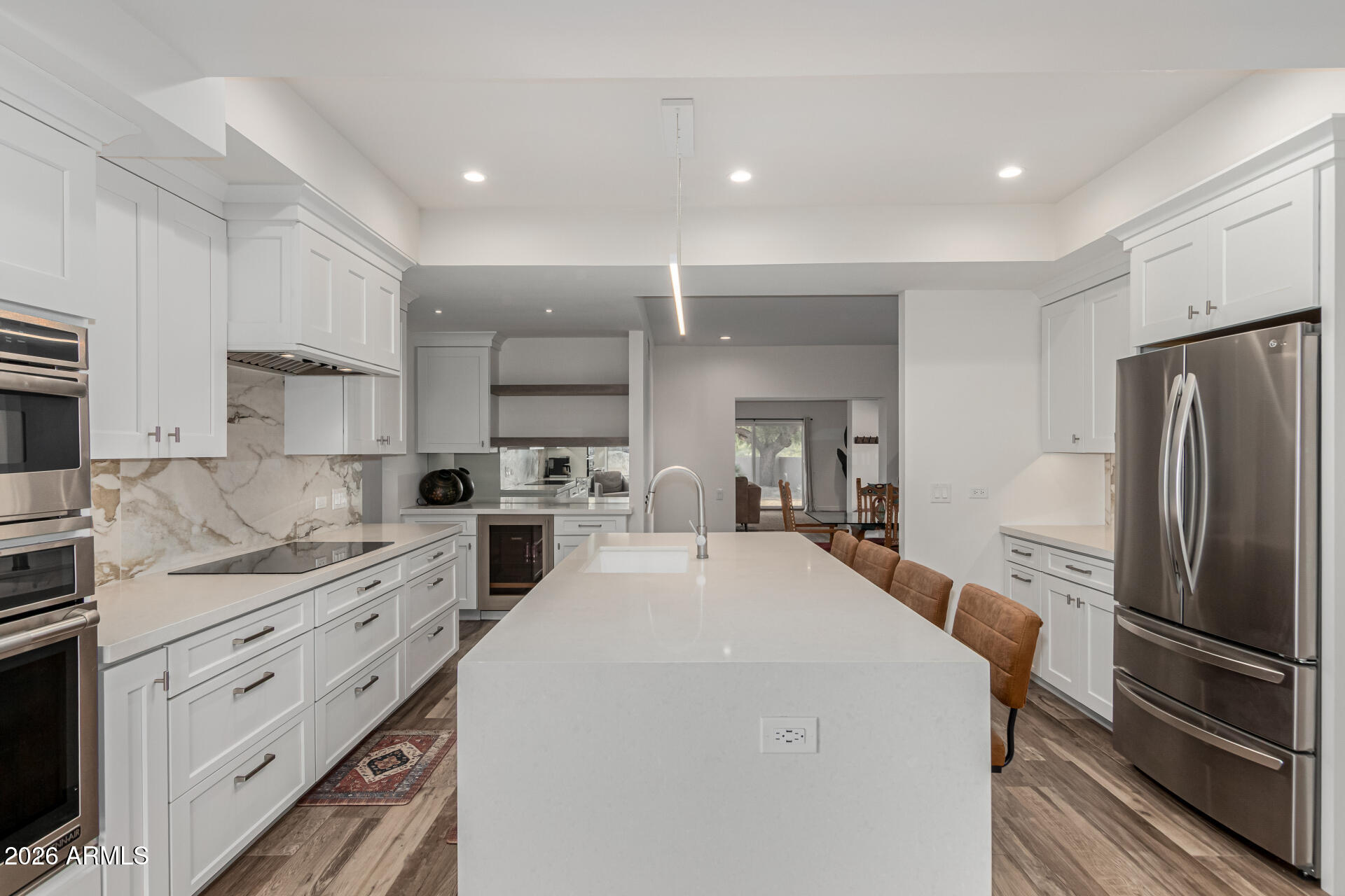 3001 Ironwood Road Carefree, AZ 85377 - Photo 13 of 31 a kitchen with white cabinets and stainless steel appliances
