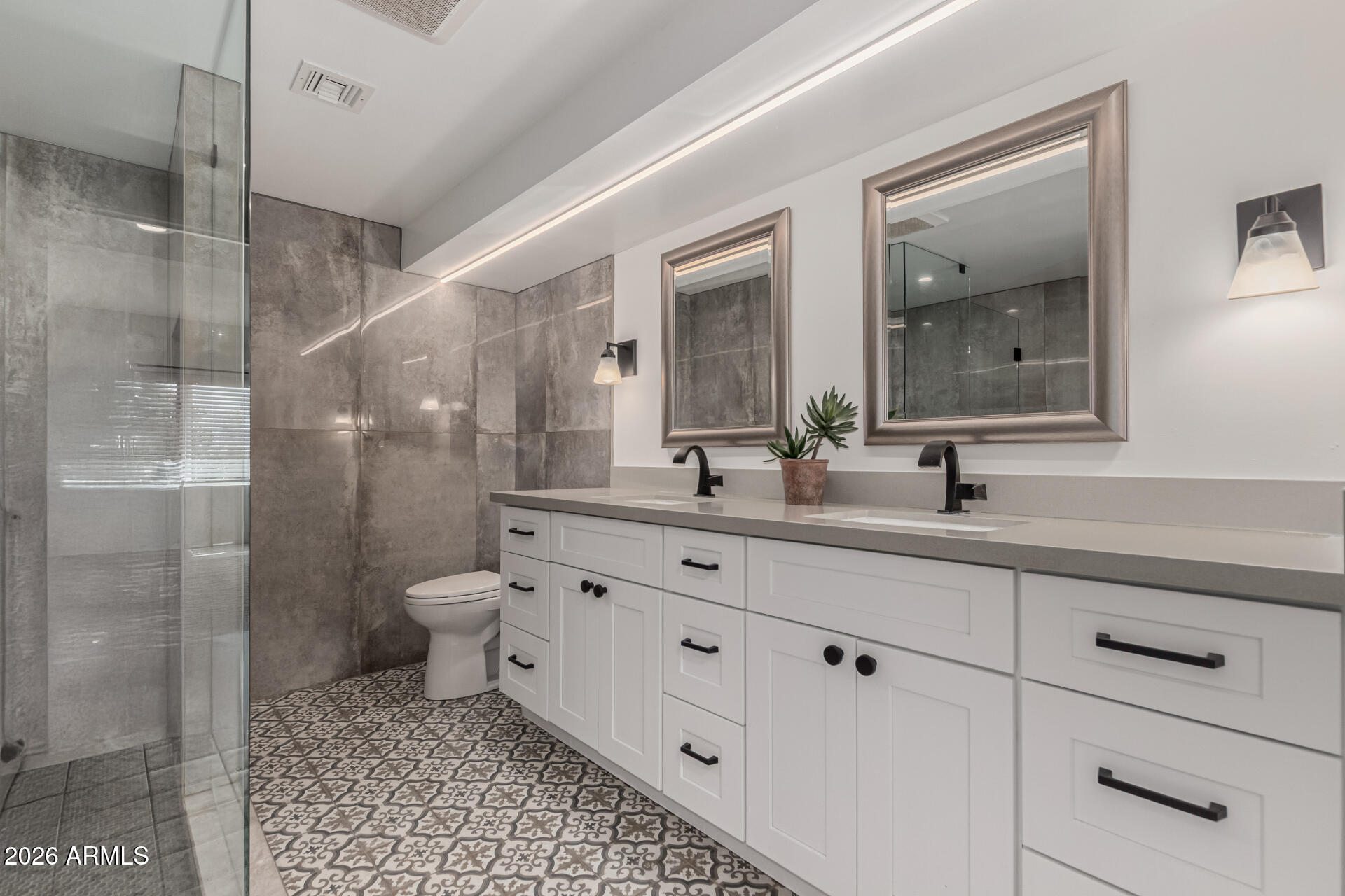 3001 Ironwood Road Carefree, AZ 85377 - Photo 20 of 31 a bathroom with a double vanity sink a toilet and a mirror