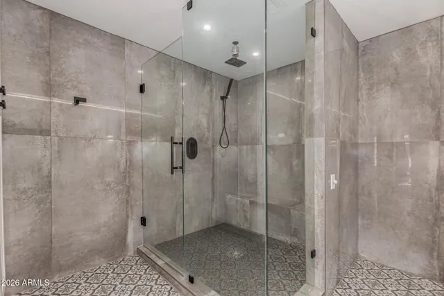 a bathroom with a granite countertop sink a large mirror and a window