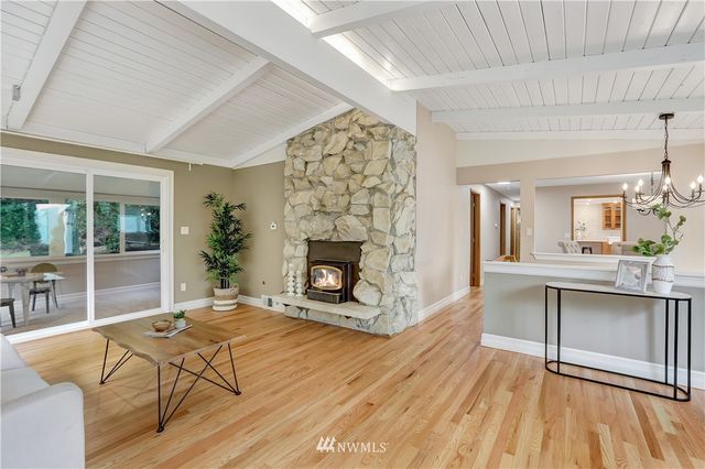 a living room with a fireplace furniture and a large window
