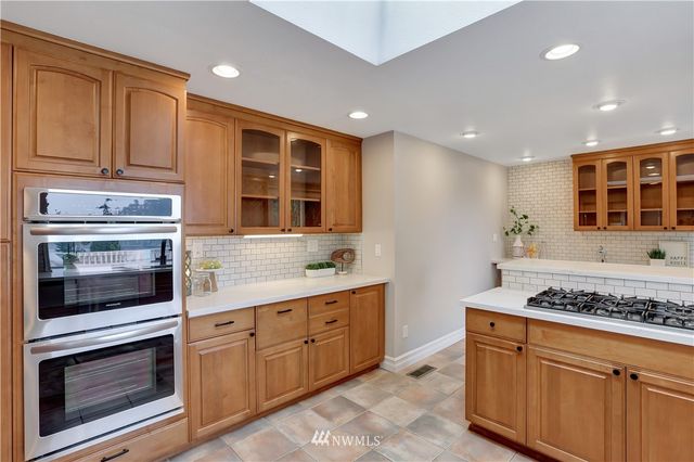 a kitchen with stainless steel appliances granite countertop a stove and a sink