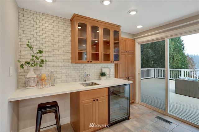a kitchen with a sink window and cabinets