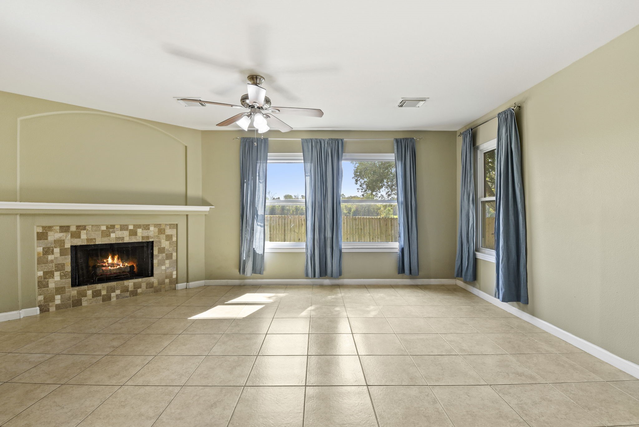 5406 Gate Canyon Court Spring, TX 77373 - Photo 11 of 47 a view of an empty room with a fireplace and a window