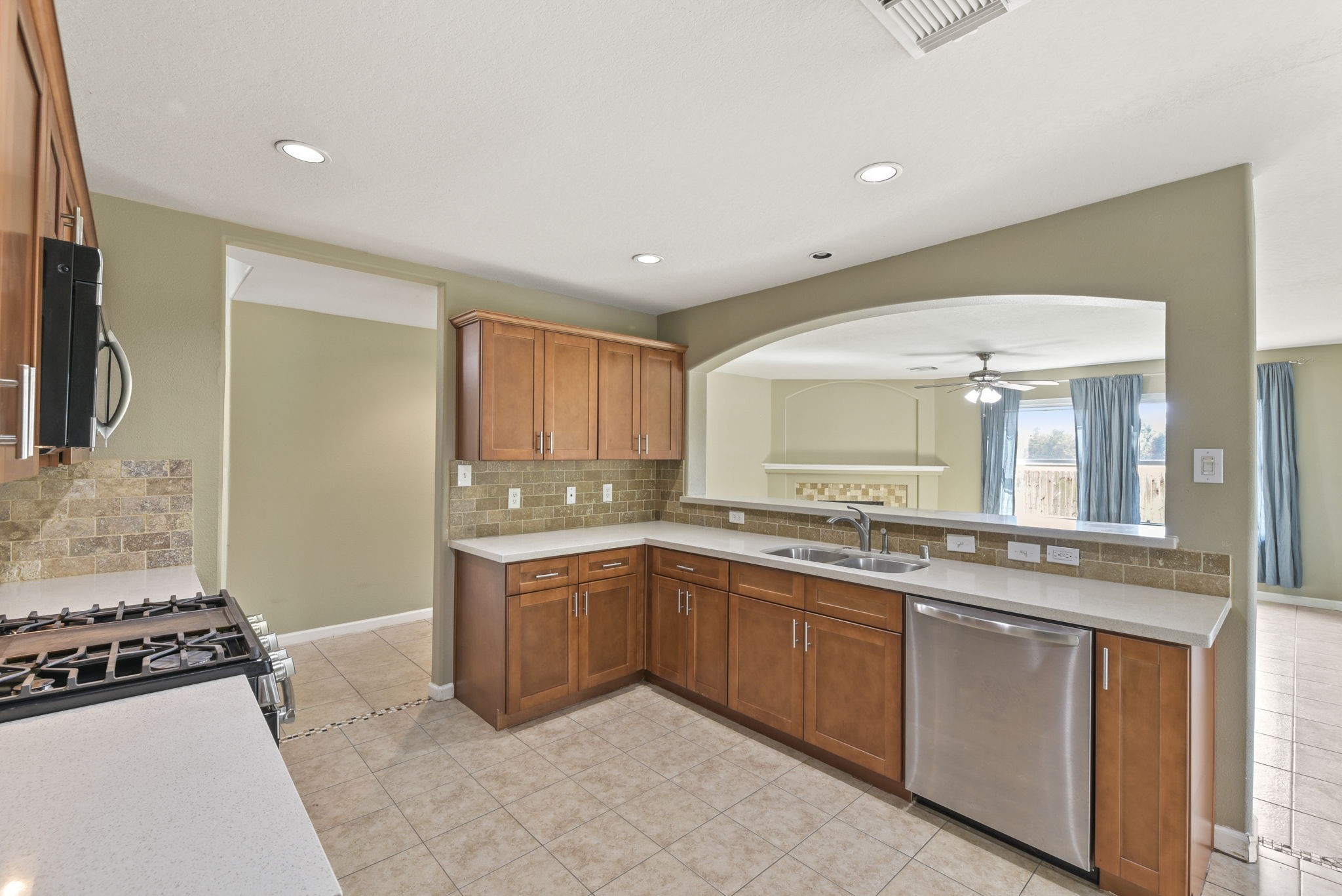 5406 Gate Canyon Court Spring, TX 77373 - Photo 15 of 47 a large kitchen with stainless steel appliances granite countertop a stove and a sink