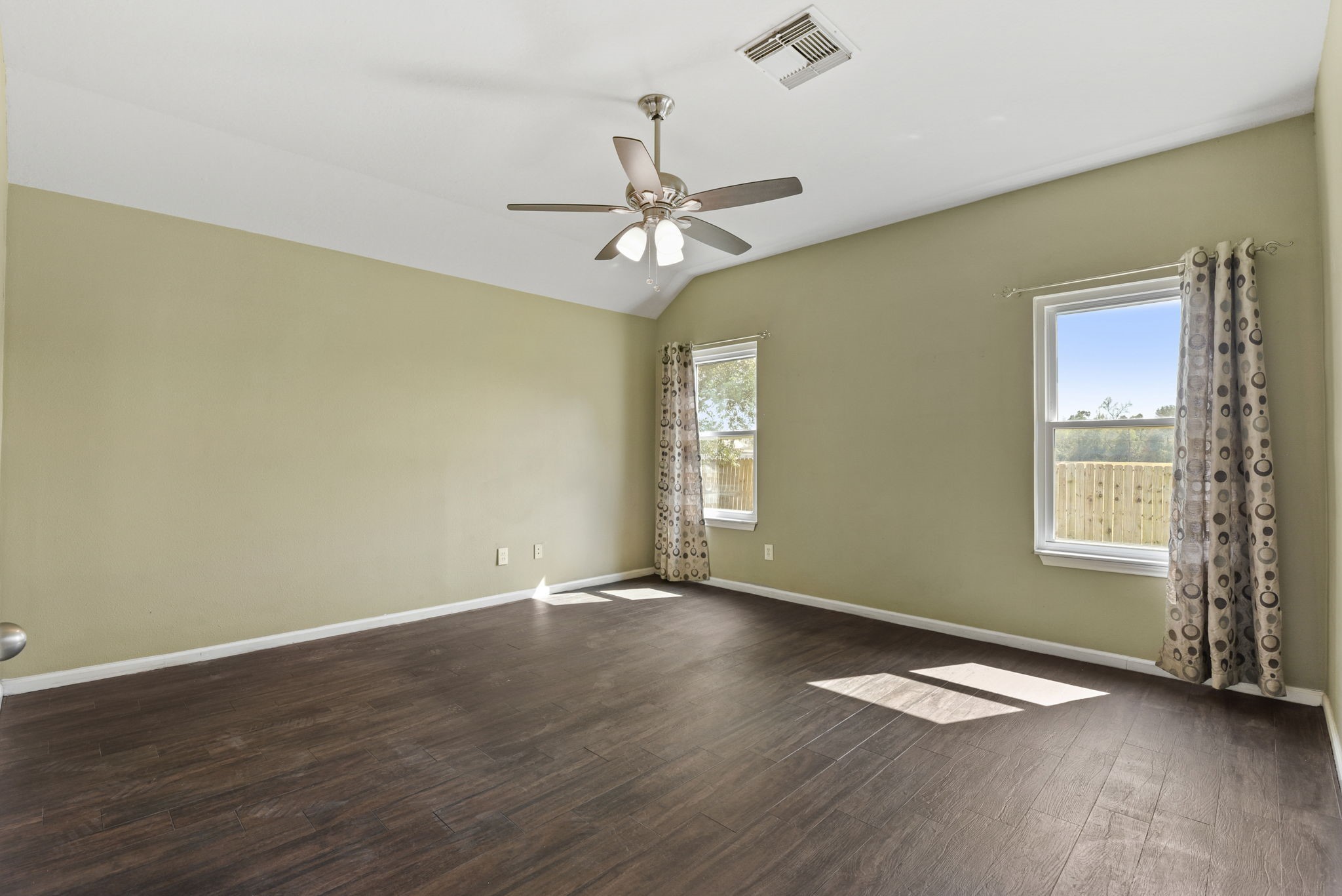 5406 Gate Canyon Court Spring, TX 77373 - Photo 18 of 47 an empty room with wooden floor fan and windows