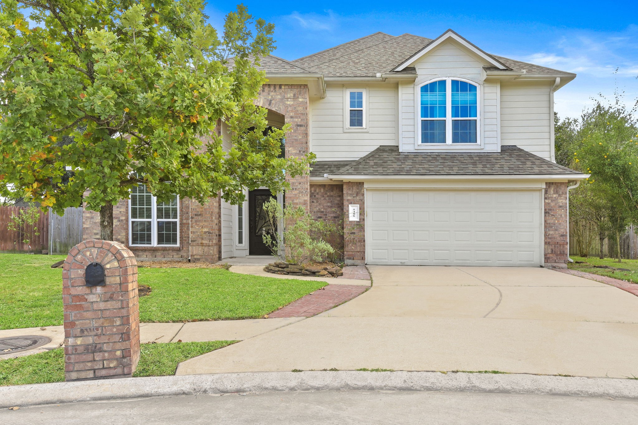 5406 Gate Canyon Court Spring, TX 77373 - Photo 2 of 47 a front view of a house with a garden and yard
