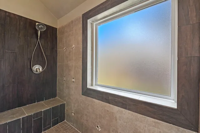 a bathroom with a bathtub and shower