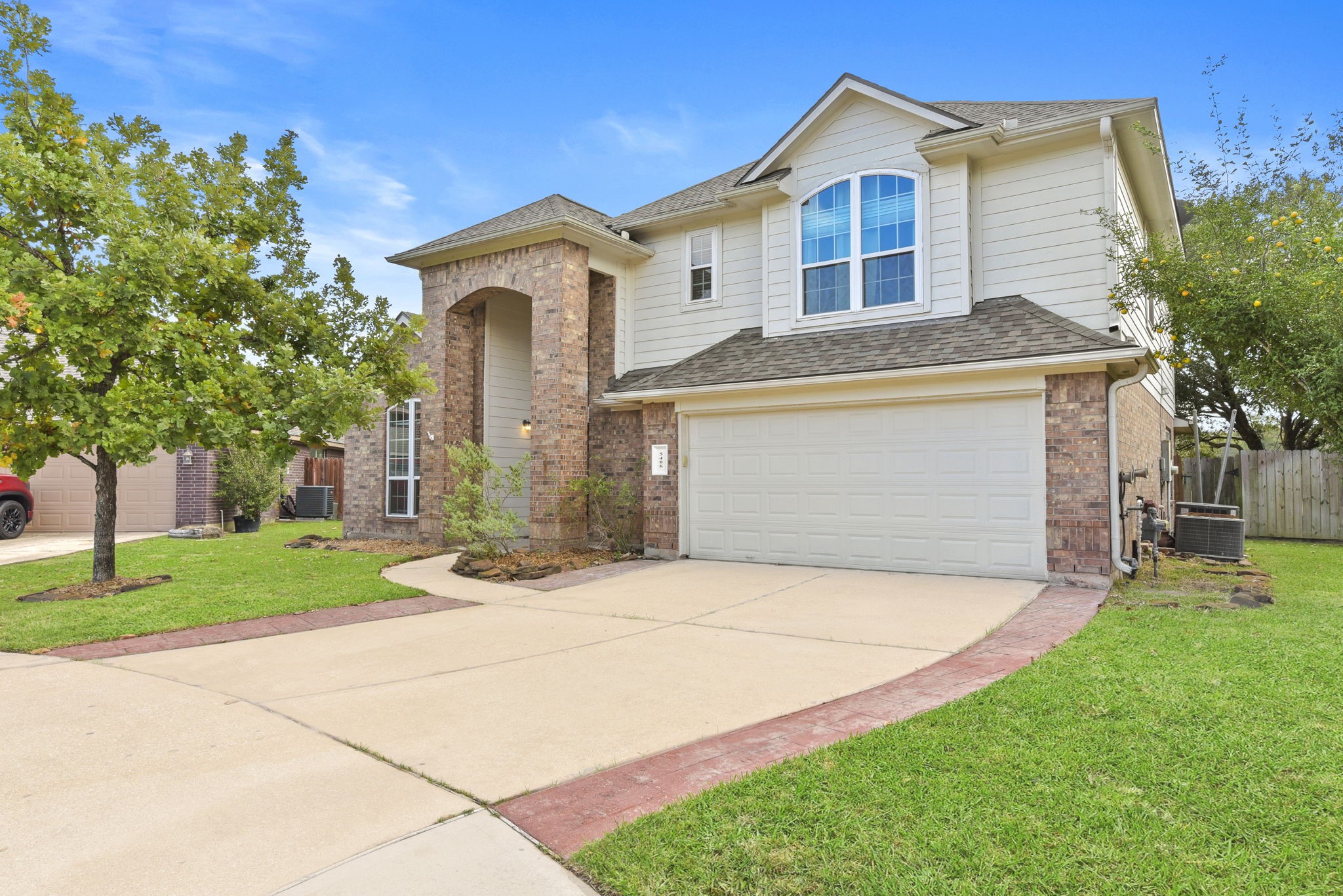 5406 Gate Canyon Court Spring, TX 77373 - Photo 3 of 47 a front view of a house with a garden and trees