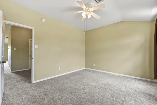 a view of an empty room with a fan