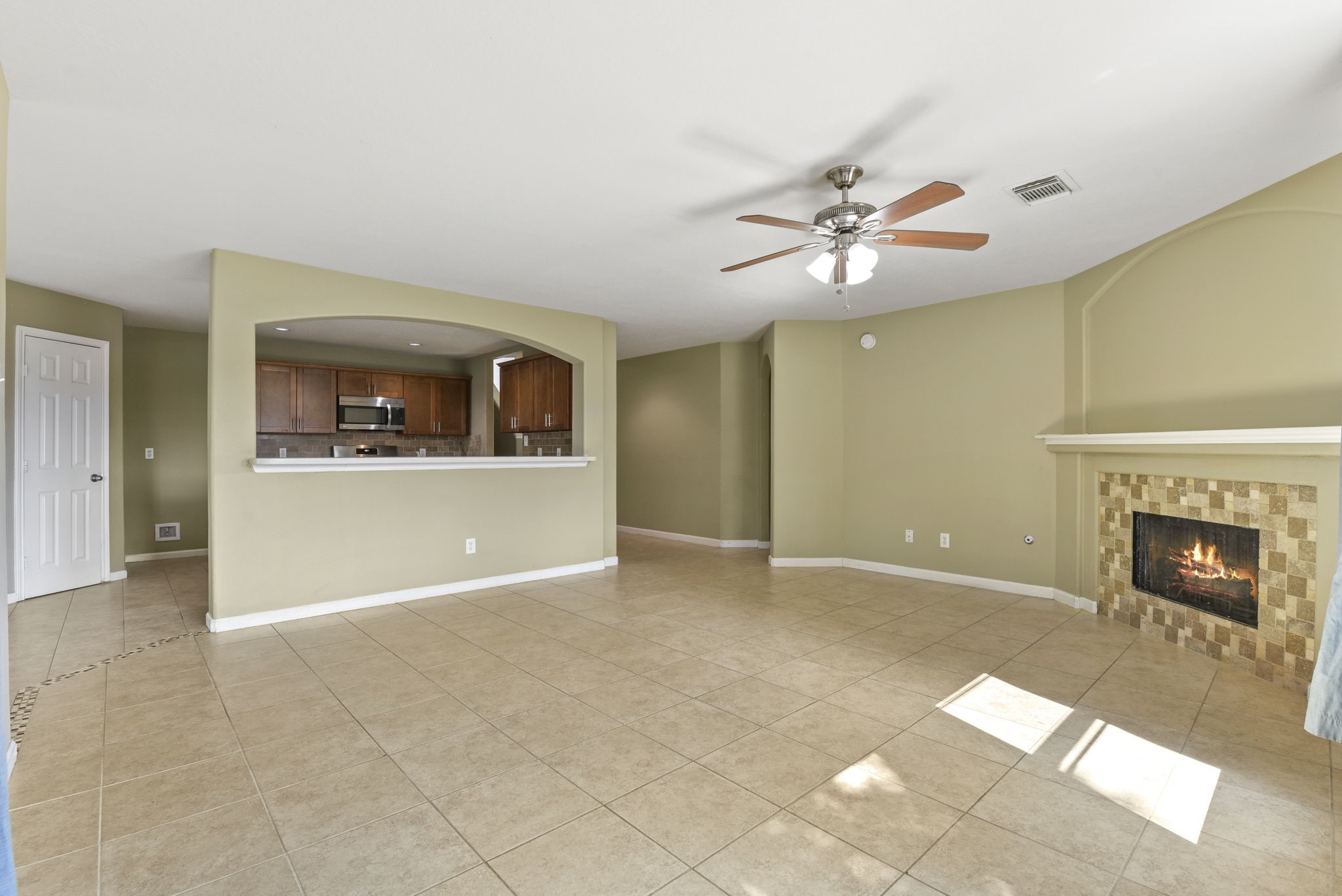5406 Gate Canyon Court Spring, TX 77373 - Photo 10 of 47 an empty room with a fireplace and fan