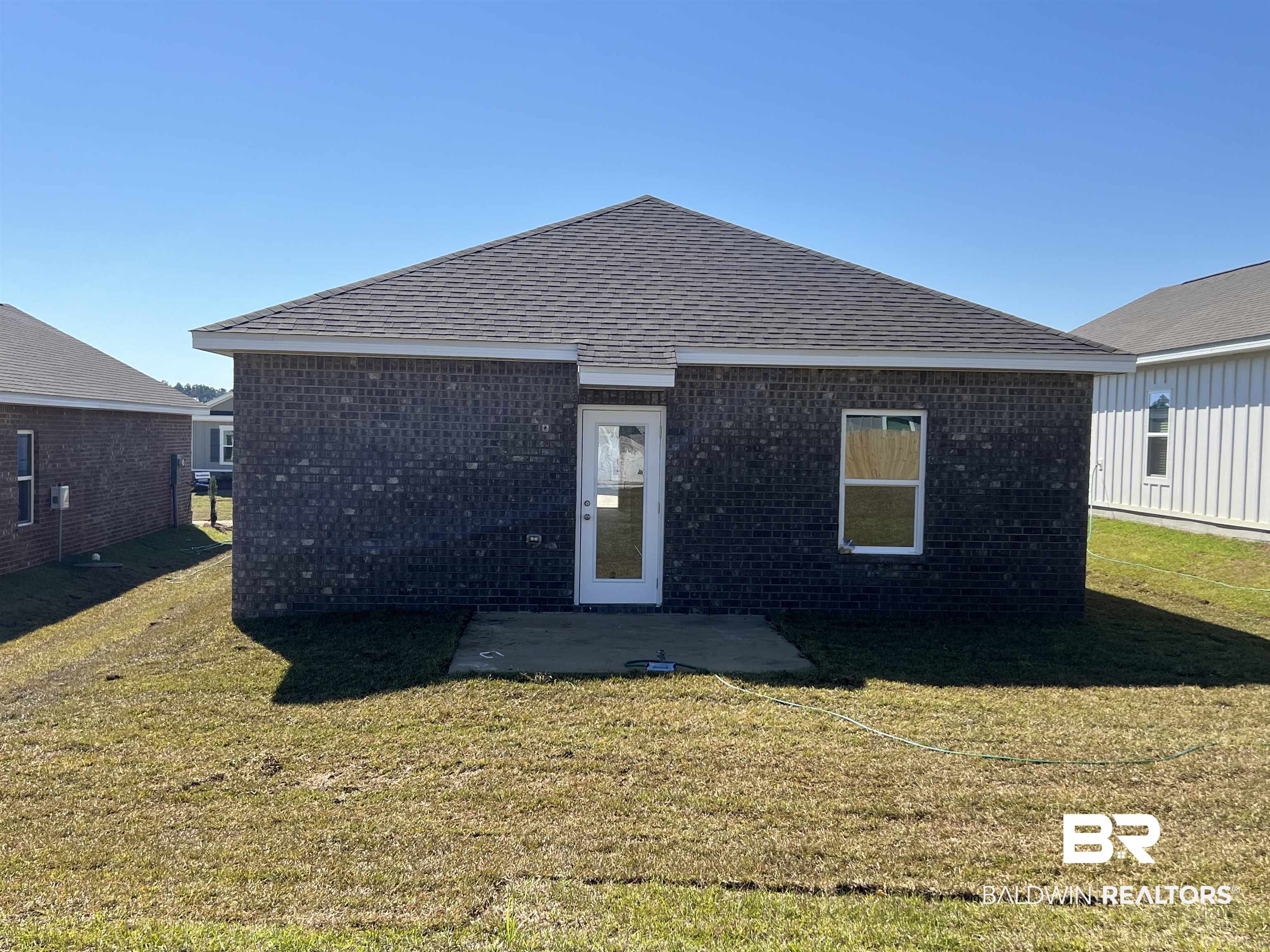 12829 Patriot Way Daphne, AL 36527 - Photo 5 of 38 Back of house featuring a lawn