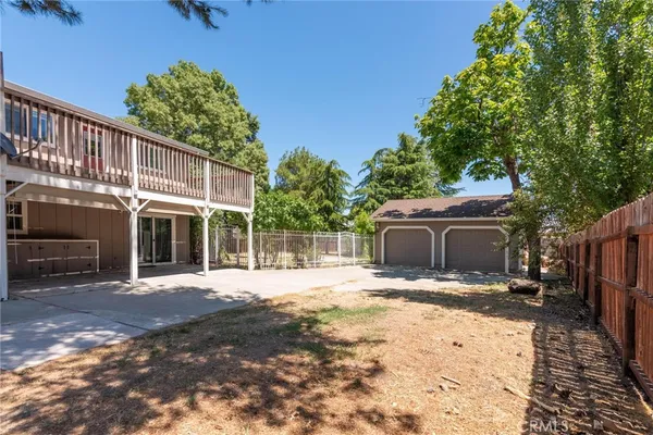 a front view of a house with a yard covered with trees