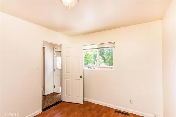 a view of a room with wooden floor
