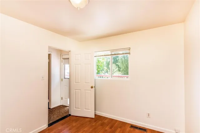a view of a room with wooden floor